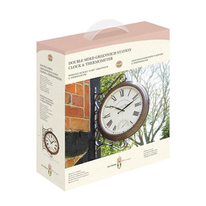 Double sided Greenwich Station wall clock and thermometer in bronze finish with Roman numerals displayed in packaging showing brick wall installation and product details