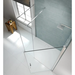 Merlyn 8 Series frameless pivot shower door with chrome hardware in modern bathroom featuring light blue subway tile walls, white floor tiles, and wooden accessories near window