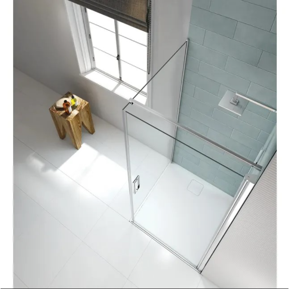 Merlyn 8 Series frameless pivot shower door in chrome finish with clear glass panels installed in modern bathroom with white tile flooring, light blue subway tile walls, and natural light from window