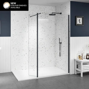 Merlyn 8mm wetroom shower panels with matte black frame and speckled white tile walls, featuring rainfall showerhead and handheld spray in modern minimalist bathroom with dark grey floor and white storage unit