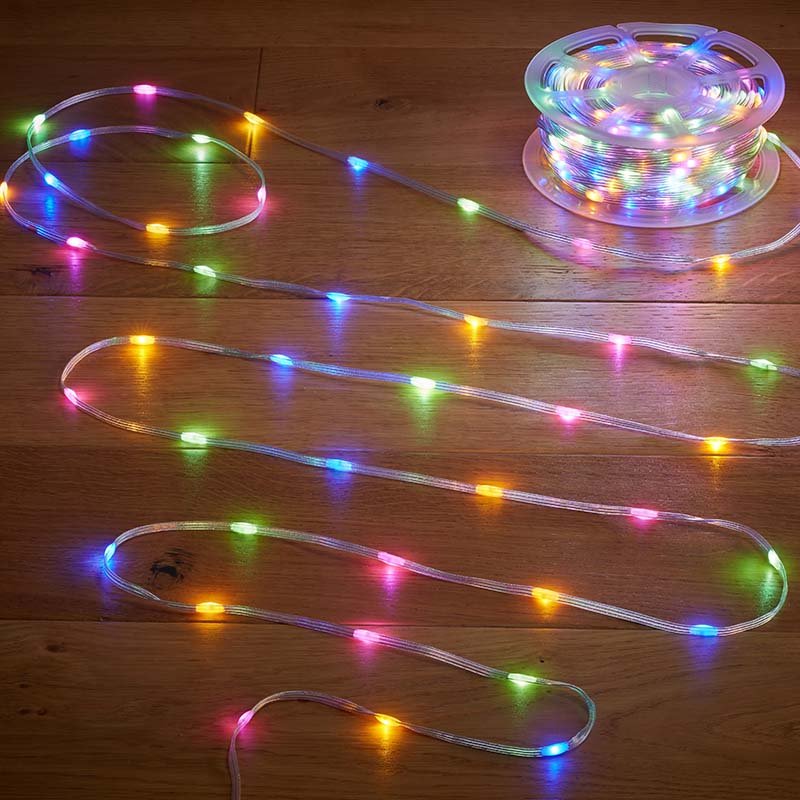 Multicolored LED string lights with 200 LEDs arranged in coiled loops on wooden surface, displaying pink, blue, green, yellow and orange lights in a flexible clear tube design