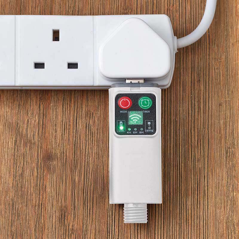 Smart WiFi-enabled wireless timer plug with digital control panel showing mode, timer, and scheduling buttons on wooden surface next to white extension cord