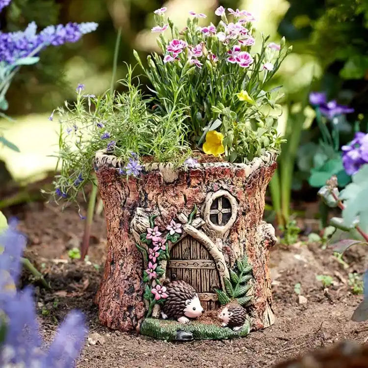 Fairy house made of wood with flowers and small animals on a garden background