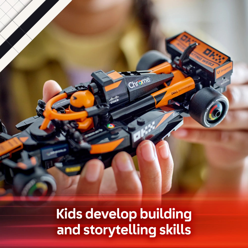 Child's hand holding orange and black LEGO McLaren F1 Team race car model with Chrome branding, featuring detailed cockpit, wheels, and sponsor logos, demonstrating building and storytelling play