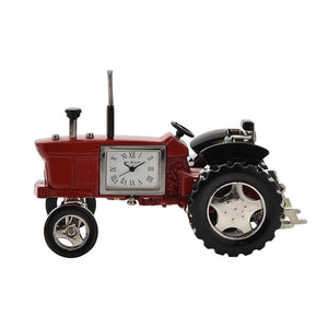 Red tractor-shaped clock with a white face on a white background