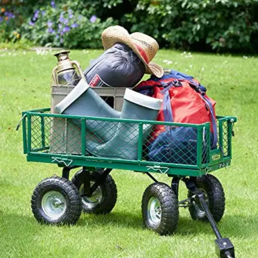 Green garden cart with tools and equipment on a grassy area