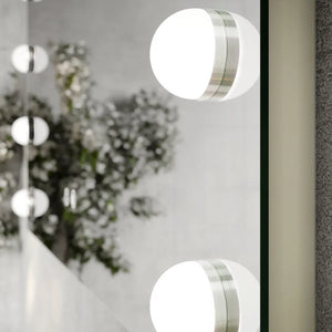 Modern LED bathroom mirror 800x700mm with integrated white circular lights and brushed silver trim, mounted on white wall above vanity with decorative white flowers and green foliage