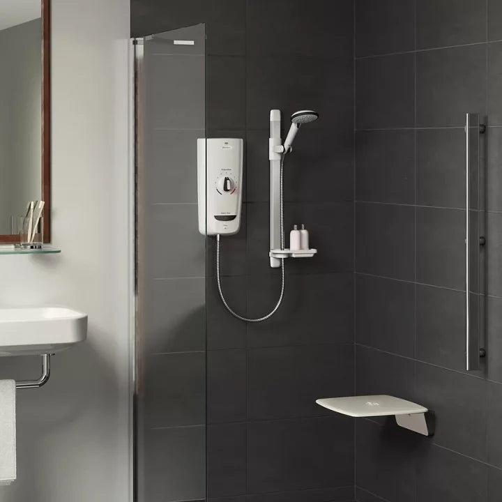 Bathroom with shower setup, including a shower head and control panel on a tiled wall.