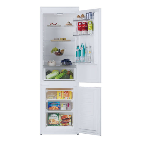White refrigerator with open door displaying various food items on a white background