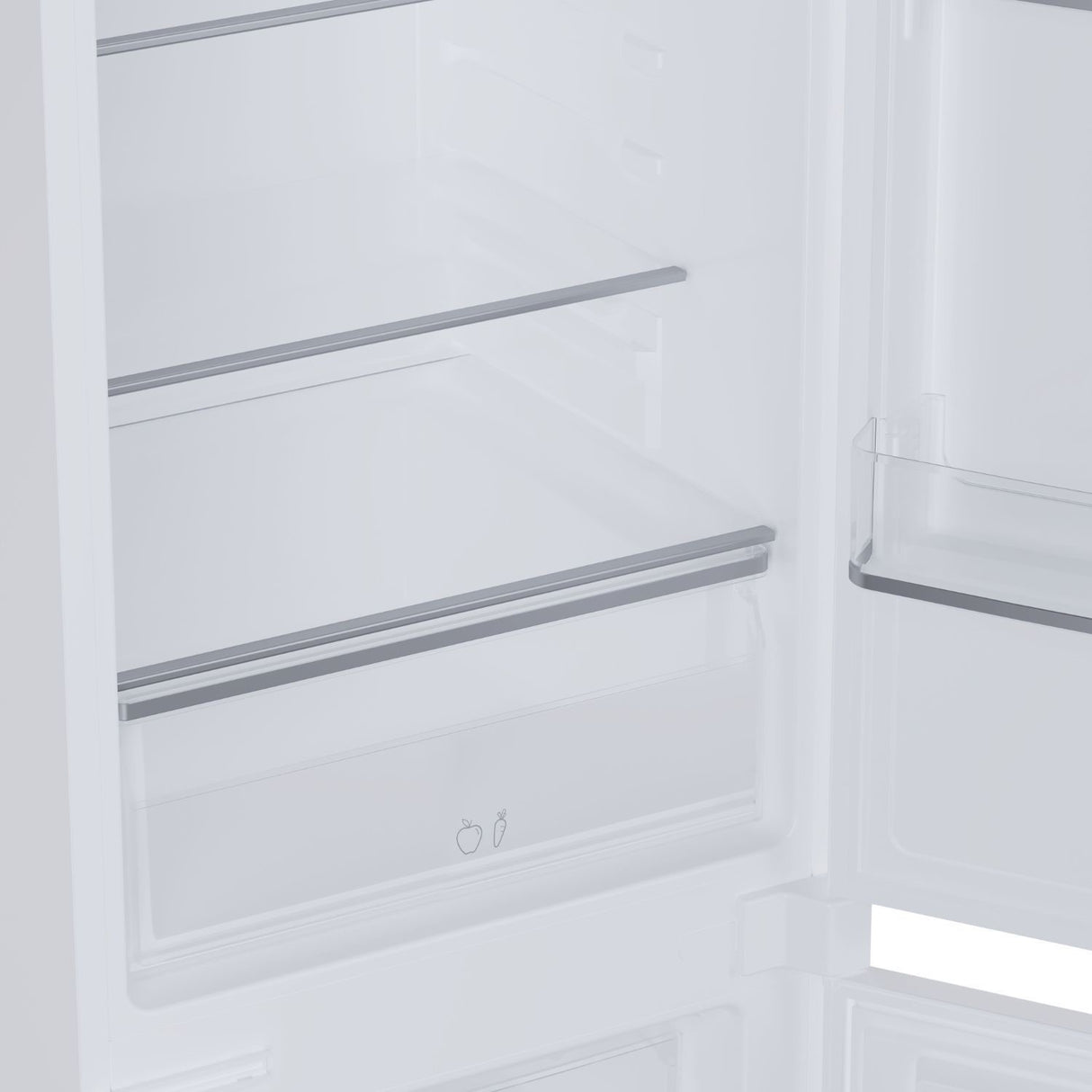 Interior view of Candy integrated built-in fridge freezer showing white shelving with metal rails, empty refrigerator compartment with fruit and vegetable drawer icons visible at bottom