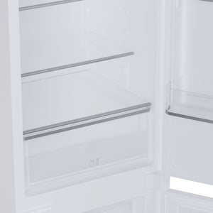 Interior view of Candy integrated built-in fridge freezer showing white shelving with metal rails, empty refrigerator compartment with fruit and vegetable drawer icons visible at bottom
