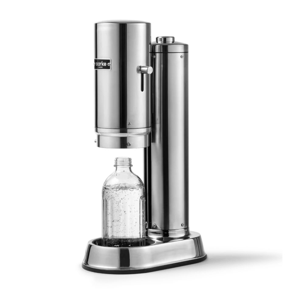 Silver soda maker with a clear bottle filled with a fizzy drink on a white background