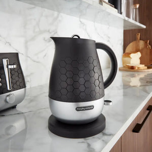Morphy Richards Cassini 1.7 litre jug kettle in moonless night black and silver on a marble kitchen countertop with hexagonal texture detailing and matching toaster in background