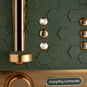 Morphy Richards Cassini 4 slice toaster in olive green with gold accents featuring hexagonal tile pattern, illuminated function buttons including defrost snowflake and cancel symbols, and control dial on brushed gold base