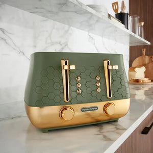 Morphy Richards Cassini 4 slice toaster in sage green and gold with hexagonal pattern design, featuring dual chrome handles and control dials, displayed on a marble countertop in a modern kitchen