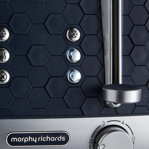 Morphy Richards Cassini 4 slice toaster in outer space black with hexagonal texture pattern, stainless steel accents, illuminated function buttons including defrost and reheat settings, and chrome lever handle with numbered heat dial control