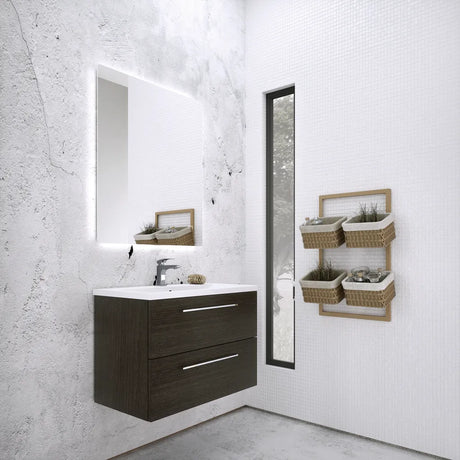 Modern bathroom vanity unit in shadow black wood with white ceramic sink, illuminated mirror, chrome tap and wicker storage baskets on white tiled wall
