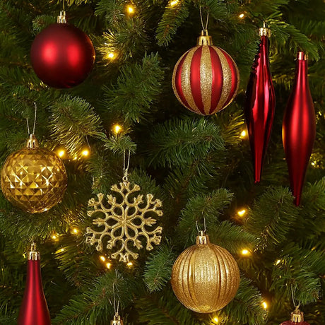 Decorative Christmas tree with red, gold, and silver ornaments.