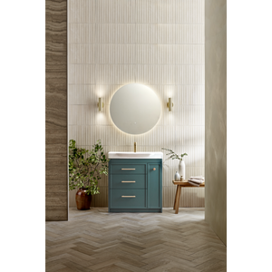 Modern bathroom vanity unit in matt coniston blue with white basin, circular illuminated mirror, brass wall sconces, herringbone wood flooring, vertical tile backsplash, potted plants and wooden accessories