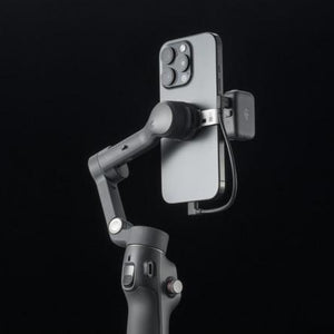 Phone holder attached to a gimbal on a black background
