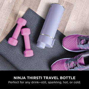 Ninja Thirsti 530ml insulated travel bottle in lavender purple displayed on gray yoga mat with pink dumbbells and pink athletic sneakers on wooden floor