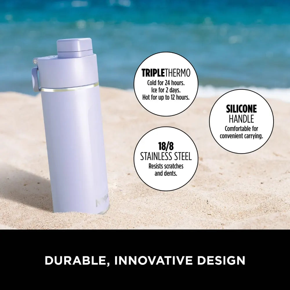 Lavender Ninja Thirsti 700ml insulated travel bottle on beach sand with ocean background, featuring triple thermo technology keeping drinks cold for 24 hours or hot for 12 hours, silicone handle for convenient carrying, and durable 18/8 stainless steel construction resistant to scratches and dents