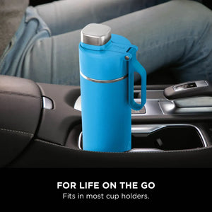 Ninja Thirsti 700ml tropical blue insulated travel bottle with stainless steel cap and handle sitting in a car cup holder, demonstrating portable hydration for on-the-go use