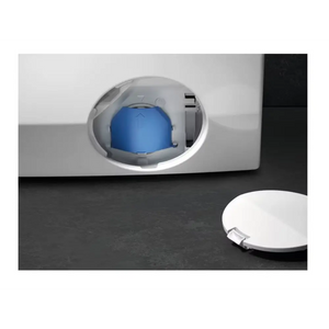 Front-loading white washing machine with blue detergent dispenser drawer open, showing 10kg capacity model on dark floor with white plate beside it