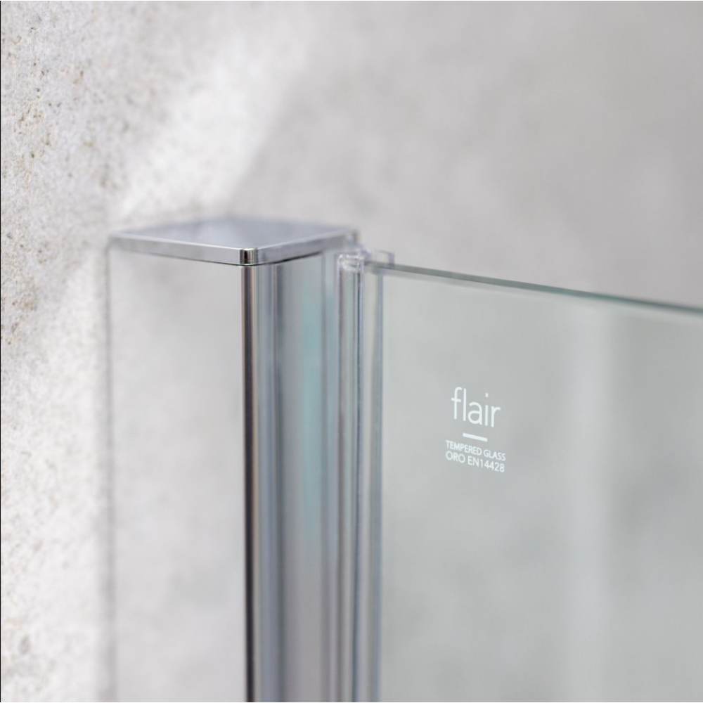 Flair ETO chrome hinge shower door with tempered glass and metal frame mounted on white textured tile wall, showing corner detail and branding
