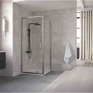 Flair ETO Infold Shower Door in chrome finish with black shower system installed in modern bathroom with grey tile walls and light wood flooring