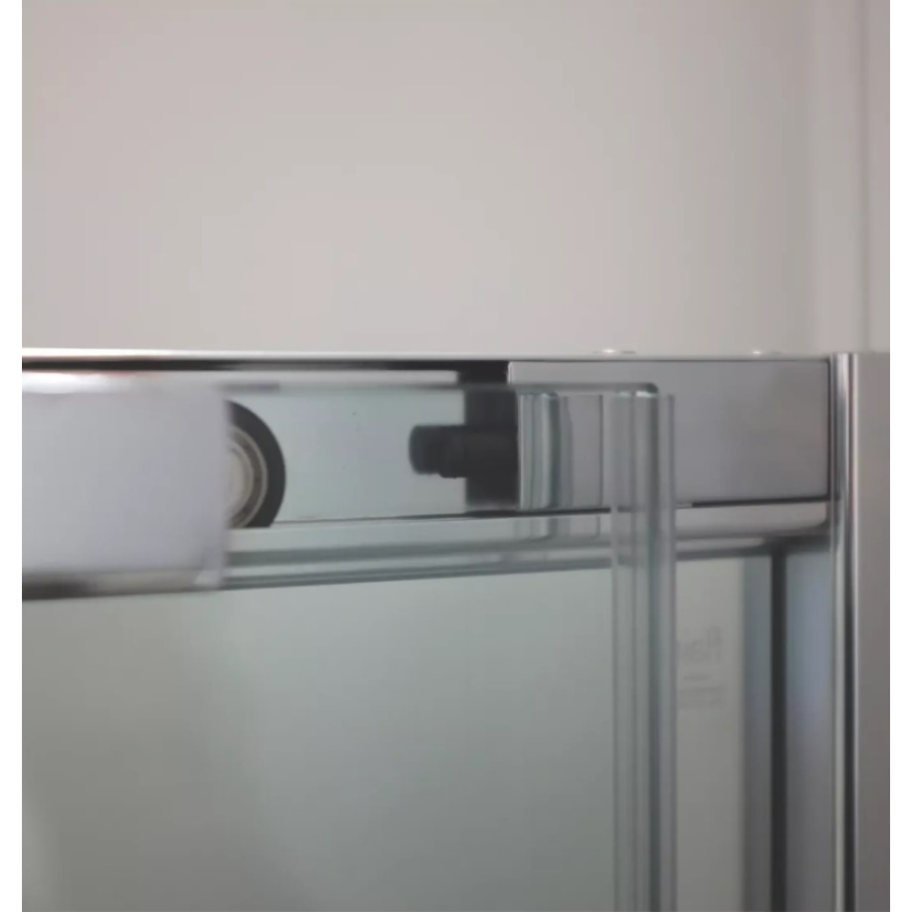 Close-up detail of chrome corner entry shower enclosure frame showing metal profile joint and structural hardware against white wall and glass panel
