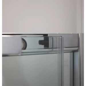 Close-up detail of chrome corner entry shower enclosure frame showing metal profile joint and structural hardware against white wall and glass panel