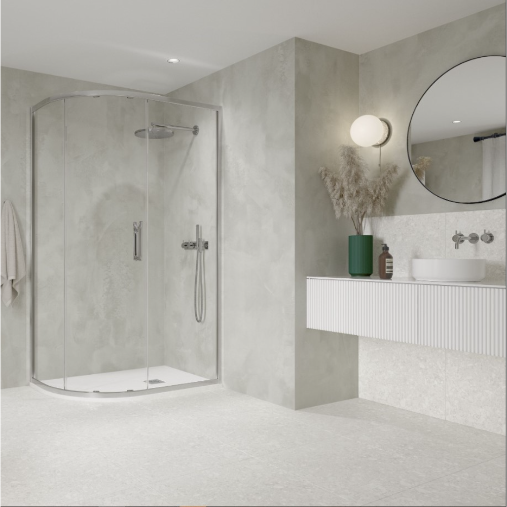 Modern bathroom with Flair ETO chrome quadrant shower enclosure, light grey concrete-effect walls, white floor tiles, floating white vanity with green ceramic accessories, round black-framed mirror and integrated lighting
