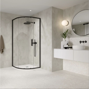 Modern bathroom featuring a Flair ETO Quadrant Shower Enclosure with matte black frame and clear glass doors, paired with a white wall-mounted vanity, round black mirror, and minimalist décor in neutral tones