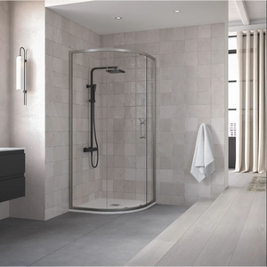 Modern bathroom with Flair ETO Quadrant shower enclosure featuring matte black framing and curved glass doors, white subway tile walls, black vanity unit, chrome towel rail, beige curtains and light wood-effect flooring