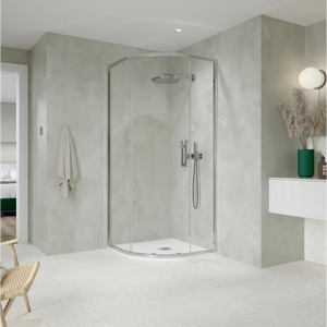 Modern chrome quadrant shower enclosure in minimalist bathroom with concrete-effect grey walls, white floor, rainfall showerhead, and contemporary vanity unit