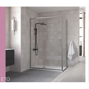 Modern bathroom featuring Flair ETO sliding shower door with black frame and clear glass panels, chrome shower head and hand rail, grey tile walls, white towel hanging on door, pink accent wall, and light wood flooring