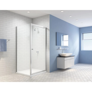 MERLYN Easy Pivot Shower Door in chrome finish installed in modern bathroom with white subway tile walls, blue painted walls, white vanity unit with round vessel sink and black countertop