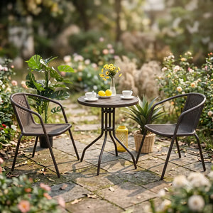 Euroactive rattan 2 seater garden furniture set with black metal frame chairs, round wooden table, yellow flowers in vase, lemons and white cups in a blooming garden setting