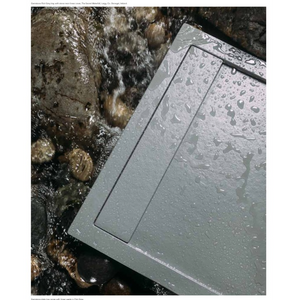 Gemstone slate gray rectangular tray with water droplets positioned next to coastal rocks and flowing seawater at The Giant's Causeway in County Antrim Northern Ireland