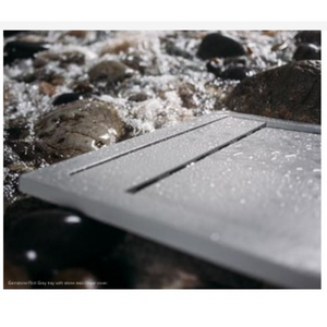 Flair Gemstone Slate rectangular tray in grey with linear detailing, displayed on decorative stones and pebbles outdoors