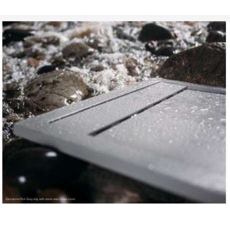 Flair Gemstone Slate rectangular tray in grey with linear detailing, displayed on decorative stones and pebbles outdoors