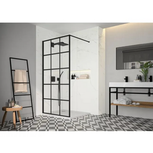 Modern bathroom featuring MERLYN black framed square wetroom panel with grid pattern design, white marble shower walls, geometric patterned floor tiles, floating vanity with wooden shelf, black mirror, towel ladder and minimalist décor