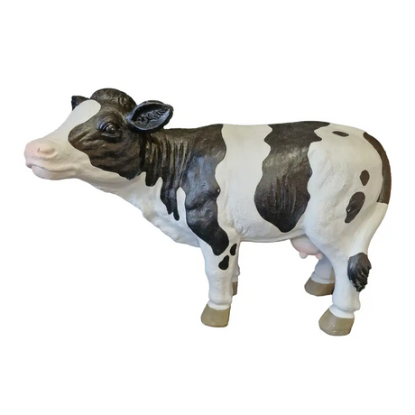 Black and white resin standing cow garden ornament with detailed painted features and realistic hooves