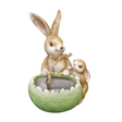 Ceramic garden planter featuring a mother rabbit with long ears wearing a tan bow and a smaller baby rabbit, both seated in a green cracked egg-shaped pot with weathered cream and tan finishes