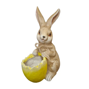 Cream-colored ceramic rabbit garden planter holding a bright yellow eggshell planter, featuring hand-painted details and a decorative rope bow around the rabbit's body