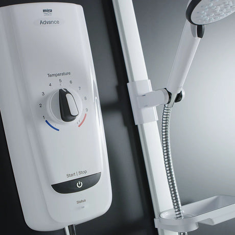 Mira Advance white electric shower unit with temperature control dial numbered 1-9, start stop power button, and chrome flexible hose with overhead rainfall showerhead