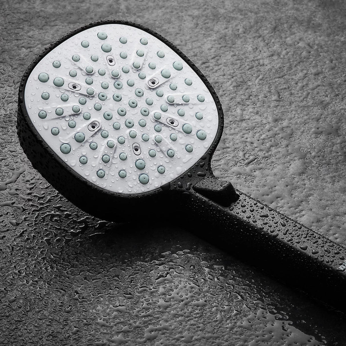 black shower head with hose and control on a white background
