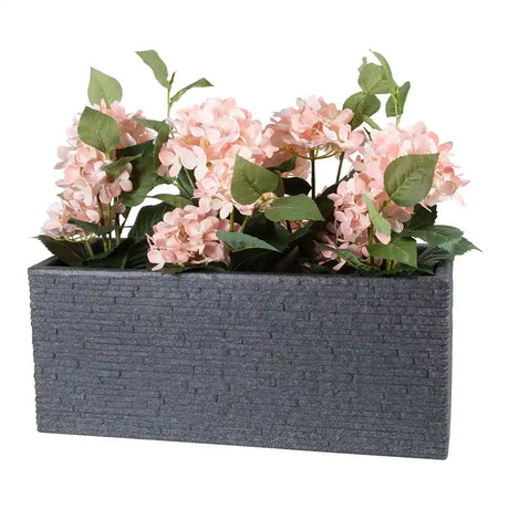 Gray slate rectangular garden planter pot with pink hydrangea flowers and green foliage arrangement