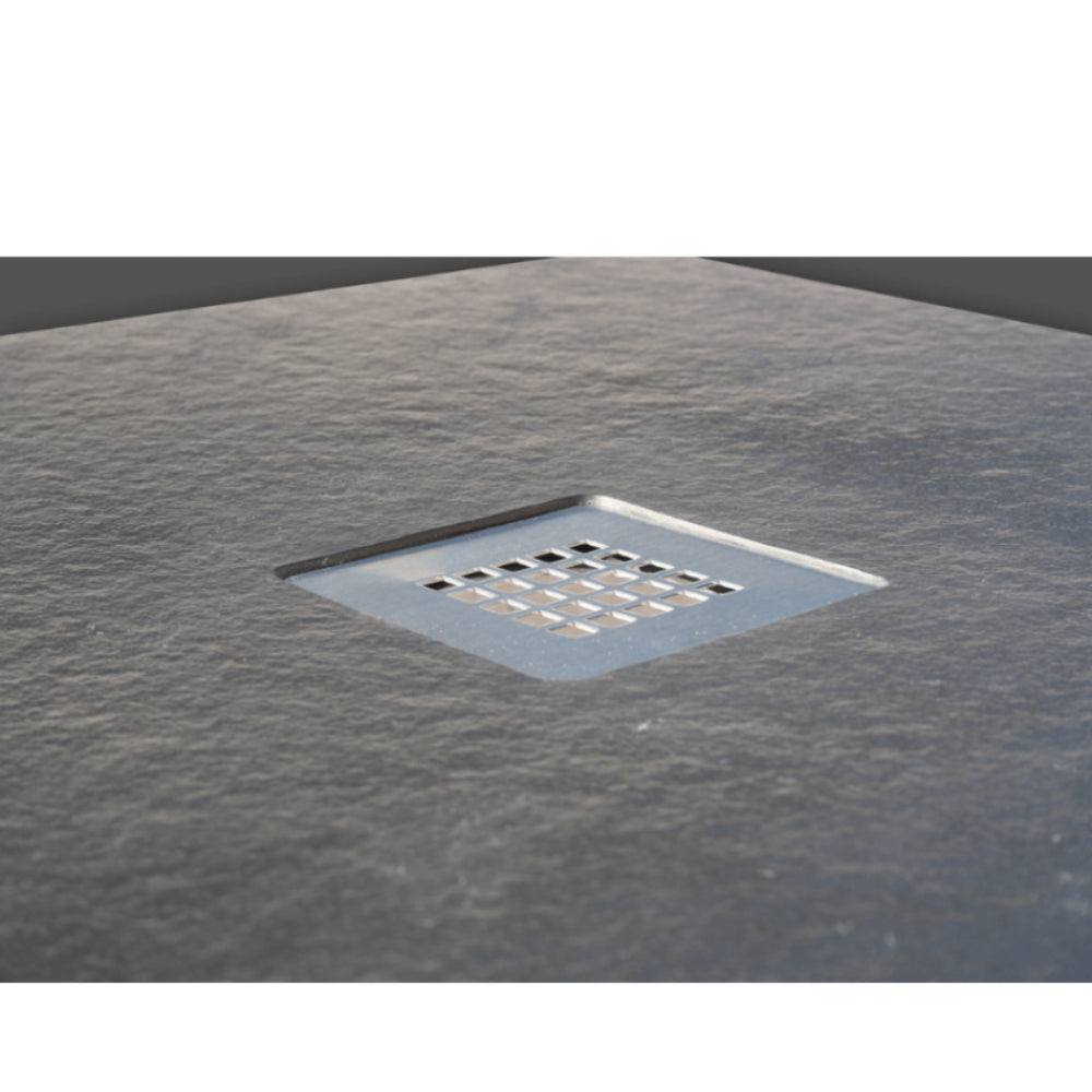 Flair Gemstone Slate Quadrant shower tray with 25mm height and square drainage holes set into textured dark grey slate surface viewed from above in bathroom setting